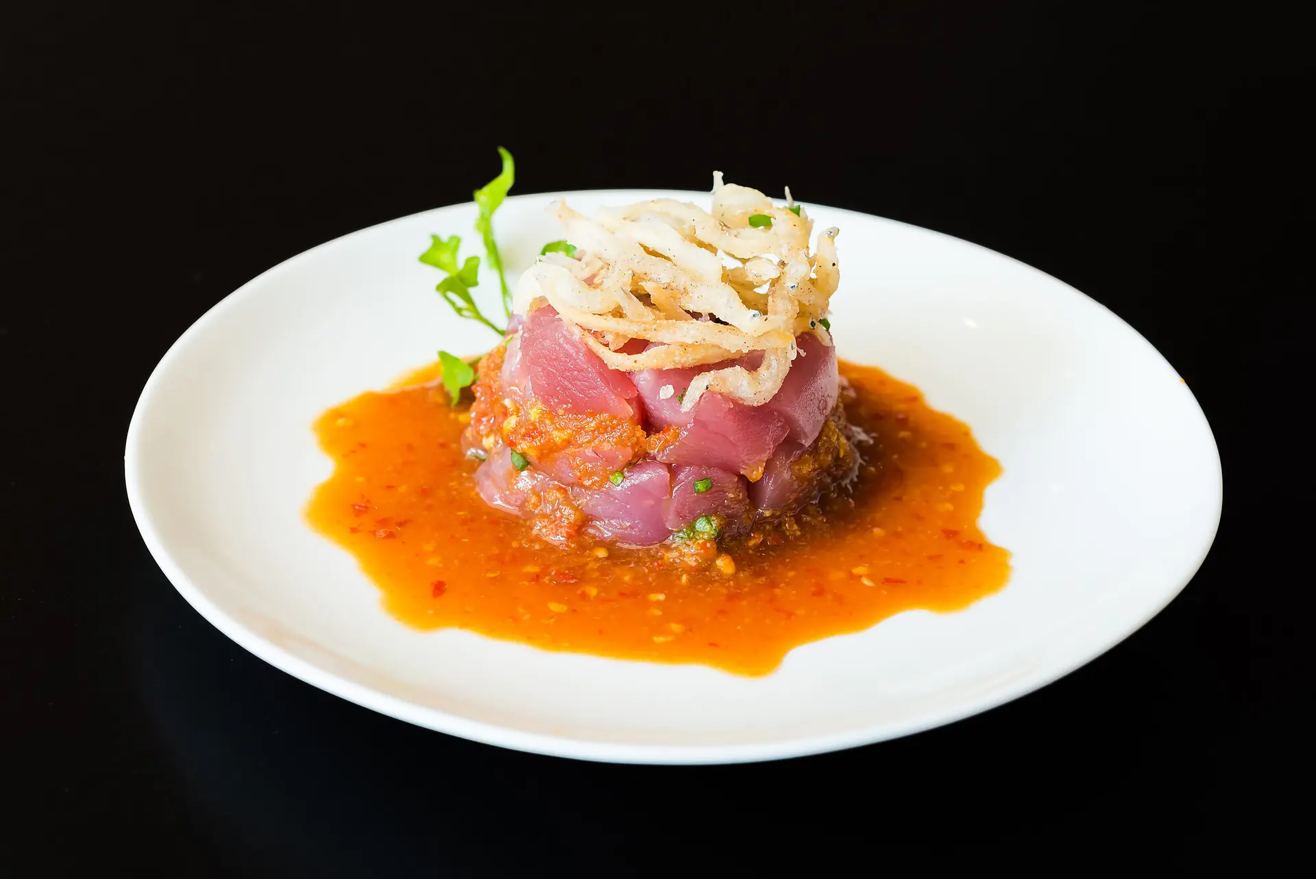 Tuna tartare with crisp shallots on a light chilli sauce
